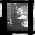 A man reading a document in his office