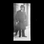 An unidentified man standing in front of a store, Colborne