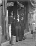 Joe Barfett of Barfett Brothers Hardware and two other men standing in the store's doorway