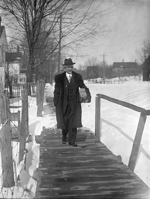 John Nunn? walking along a wooden sidewalk