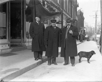 Three men standing in front of a jewellery store, King Street, Colborne