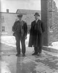 Photograph of two men standing near a livery business, Colborne, Cramahe Township