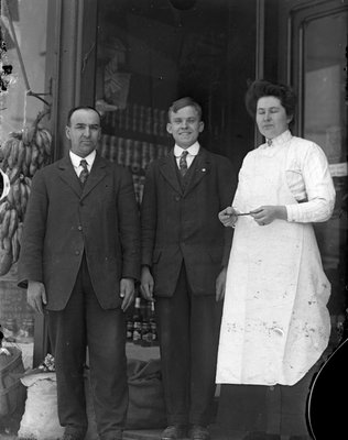 Mr. J. A. Lemon, ?Mrs. Lemon and a young man outside Lemon's Grocery, Colborne