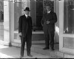 Photograph of Frank Griffis and an unidentified man standing in front of W. F. Griffis Drug Store, King Street East, Colborne