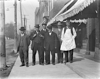 Vincent Cornwell and five unidentifed men standing in front of a grocery store