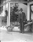 Charles Brown? in front of W.H. Edwards Grocery Store, Colborne