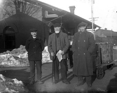 Three men at the Grand Trunk Railway, later the Canadian National Railway Station, Colborne