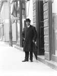 An unidentified man standing in front of a store, Colborne