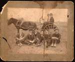 Group photograph of Bert Cochrane and unidentified men posing in front of a pony cart