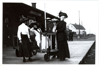 Colborne women modelling Miss Culver’s hats at the Grand Truck Railway Station, Colborne