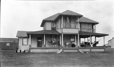 Women relaxing on the porch at Griffis' summer house