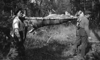 Deerhunters transporting a stag