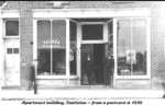 Postcard of Peabody's(?) storefront, Naish Block, Spring Street, Castleton