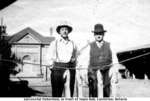 Two men in front of Castleton Town Hall, Cramahe Township