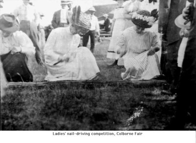 Ladies participating in a nail driving competition, Colborne Fair