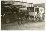 Everet Rowsome, Mrs. Rowsome and Charles in front of a Rowsome's Bakery horse drawn wagon and a Rowsome's Bakery Truck, Colborne