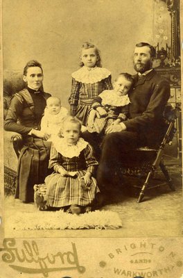 Studio portrait of William L. Hennessey, Catherine (nee Mutton) Hennessey, William &quot;Bertram&quot; (baby), Beatrice, Minnie, and Harry