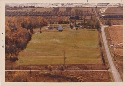 Aerial view of Enid Rodgers’ Farm, Canadian Pacific Railway station, and St. Lawrence Cement Quarry, Ogden's Point, December 1974