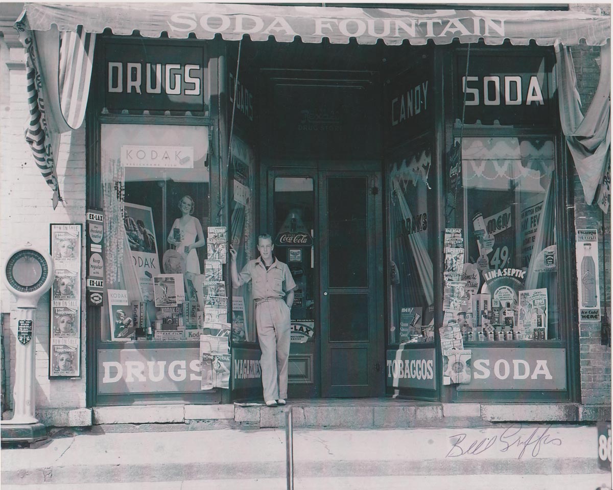 Photograph of Bill Griffis in front of Griffis Drug Store, Colborne, Cramahe Township