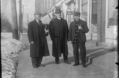 Three men standing in front of a jewellery store, King Street, Colborne