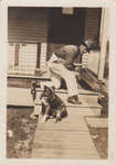 Man with his dog on a porch