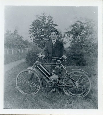 Postcard of a young man with motorized bicycle