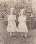 Two girls in identical dresses