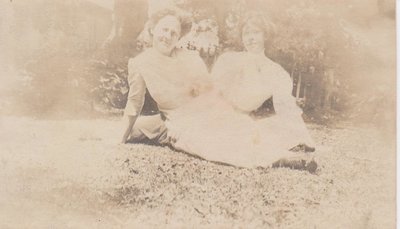 Two young women sitting outside