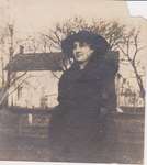 Woman standing in front of a house