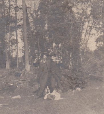 Two young men and their dogs