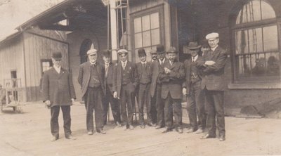 Group photograph of unidentified men, Grand Trunk Railway Station, Colborne, Cramahe Township