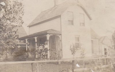 Couple in front of their house