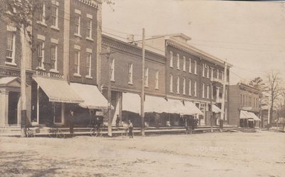 Postcard of King Street storefronts including Griffis Druggist and Standard Bank, Colborne