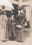 Postcard of three women in front of a store, possibly King Street, Colborne, ca.1912