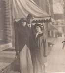 Postcard of two women and a man in front of a store, possibly King Street, Colborne, ca.1912