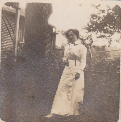 Postcard of a young woman in a backyard