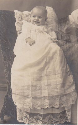 Postcard of baby in a christening gown, studio portrait