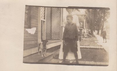 Postcard of mother and son with a Jack Russell terrier