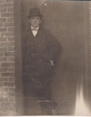 Postcard of a man standing in a doorway