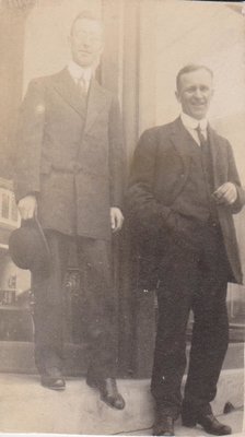 Postcard of two men standing in a doorway, possibly Standard Bank, Colborne