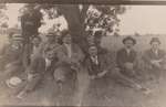 Postcard of a group of men under a tree