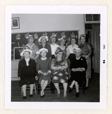 Photograph of Mrs. Grafton, Mrs. T.M. Gresham, Mrs. S.J. Cox, Miss E. Simmons, Mrs. E. McLaughlin, Mrs. J. G. Honey, Mrs. G. MacGregor, Mrs. E. Adams and Miss Milligan, Colborne Women's Institute Scrapbook