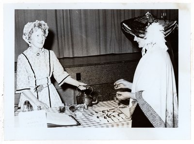 Photograph of Amy Gresham and Ellen MacGregor at Tweedsmuir tea fundraiser, Colborne Women's Institute Scrapbook