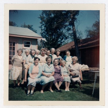 Photograph of Margaret Mackie, Gertie Velleau, Goldie Cox, Grace Corbyn, Kate Thompson, Maggie Mackie, Mrs. Roy Packard, Flossie Pebbles, Grace MacGregor, Gladys Hart, Ellen MacGregor, Gert Bradford, Ida Pebbles, Amy Gresham and Marjorie Rutherford, Colborne Women's Institute Scrapbook