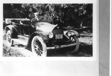 Clayton Dick posing in his new Overland automobile.