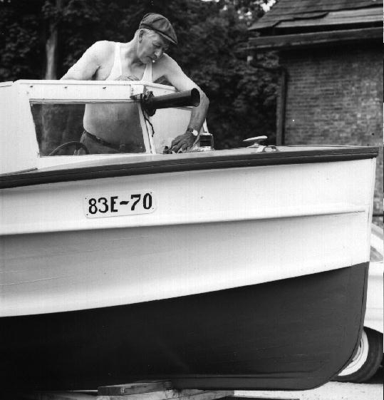 Perc Donaldson spruces up his boat, 1962