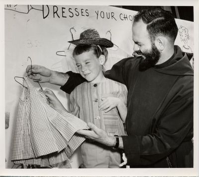 Father Francis at Holy Cross Festival Clothing Booth, 1962