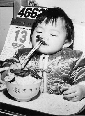 Photograph published in the <i>Georgetown Herald</i> of a child celebrating Lunar New Year, 1964