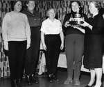 Mrs. Sam Mackenzie presents curling trophy to Doris Barrager, Margret Bilsborrow, Helen Archer, and Myrtle Scott