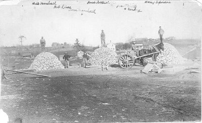 Workmen pose with stone cut for a Kiln